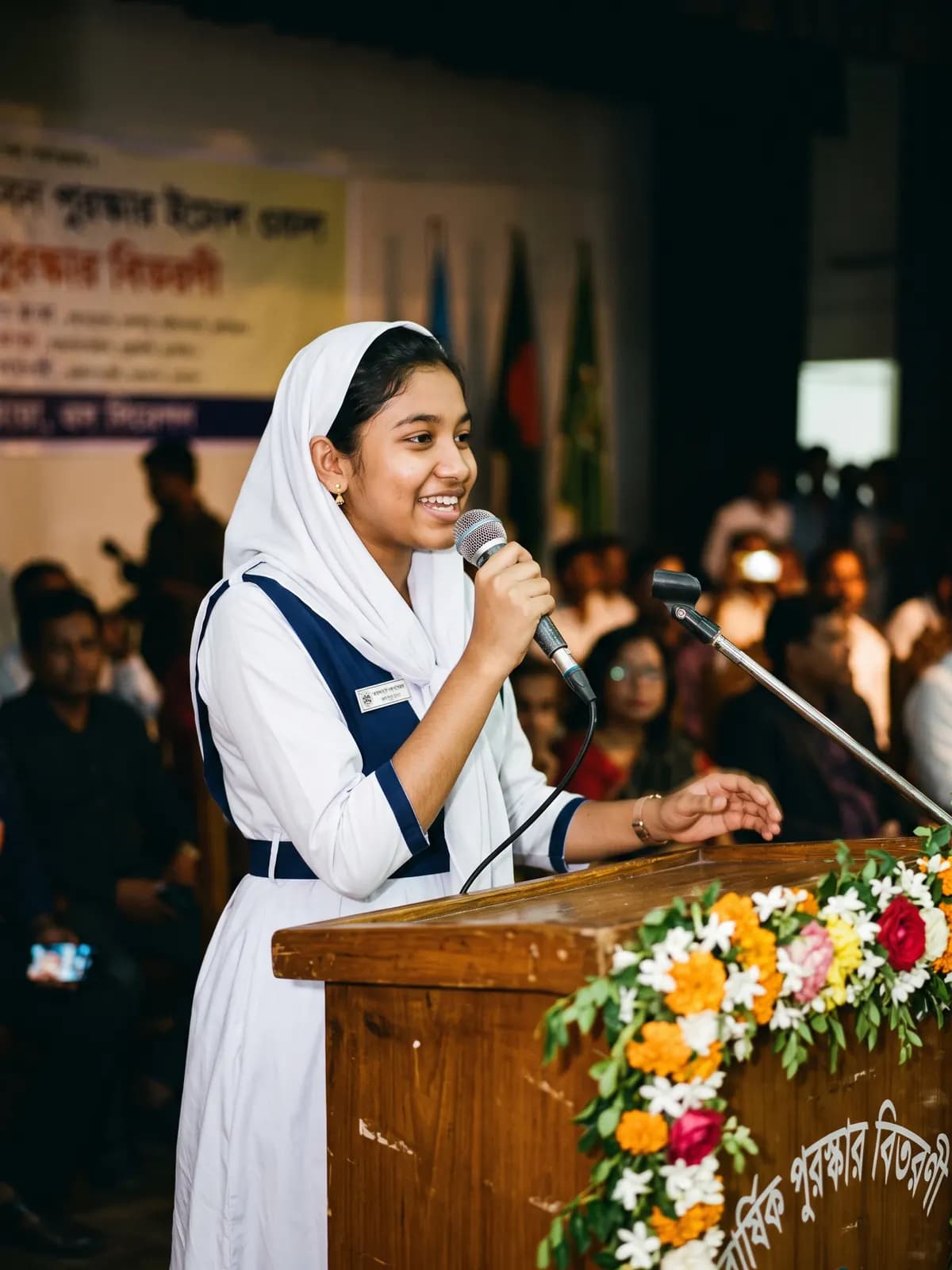 A student speaks at the podium during the prize-giving ceremony